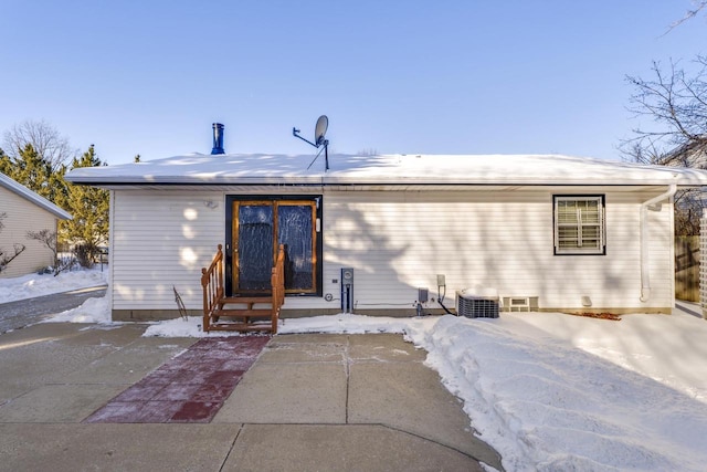 snow covered property featuring entry steps