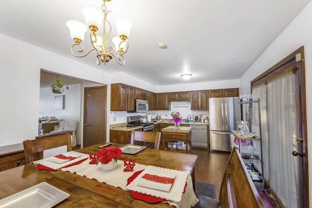 dining space featuring a chandelier and dark wood finished floors