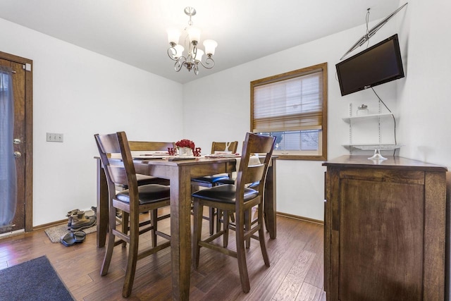 dining area with an inviting chandelier, baseboards, and dark wood finished floors