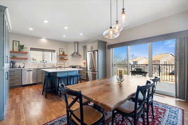 dining area featuring light wood finished floors and recessed lighting