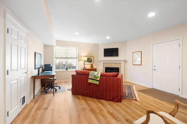 living area with recessed lighting, visible vents, light wood-type flooring, baseboards, and a tile fireplace