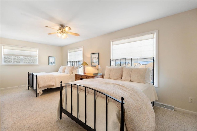 bedroom with light carpet, baseboards, visible vents, and ceiling fan