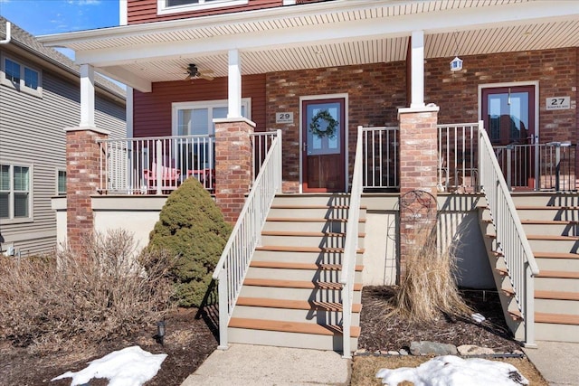 entrance to property featuring covered porch and brick siding