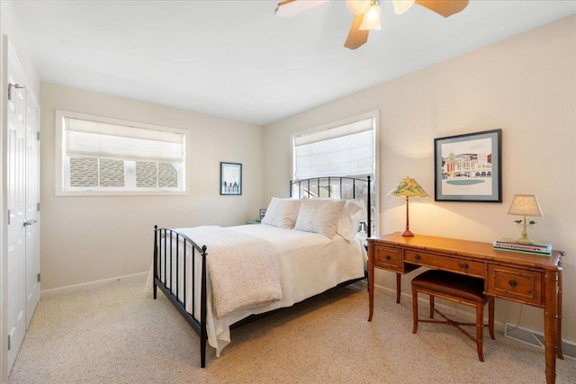 bedroom with visible vents, multiple windows, baseboards, and light colored carpet