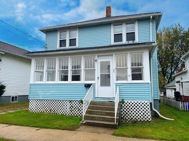 traditional style home featuring entry steps and a chimney