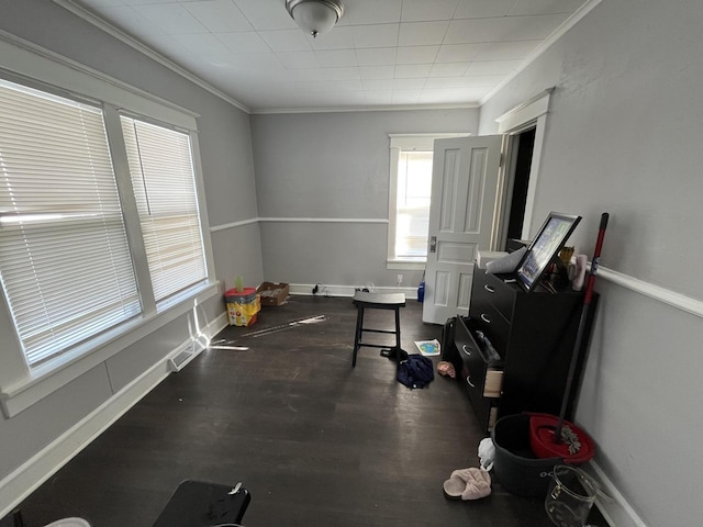 interior space with ornamental molding, dark wood finished floors, and baseboards