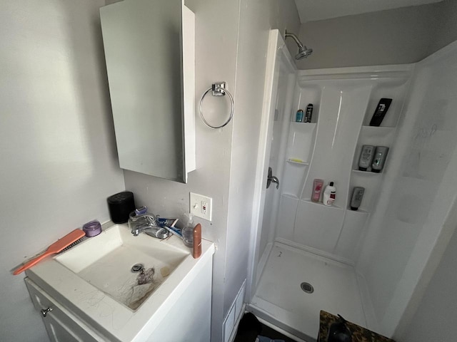 bathroom featuring a sink and walk in shower