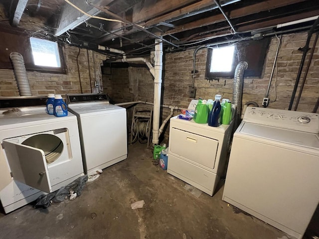 laundry room featuring laundry area, plenty of natural light, and separate washer and dryer