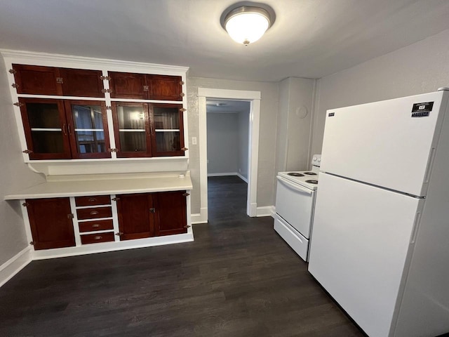 kitchen featuring white appliances, dark wood-style flooring, baseboards, light countertops, and glass insert cabinets