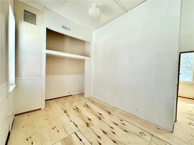 unfurnished room with visible vents and light wood-style flooring