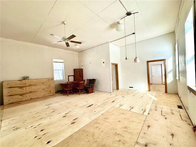 interior space with visible vents and ceiling fan