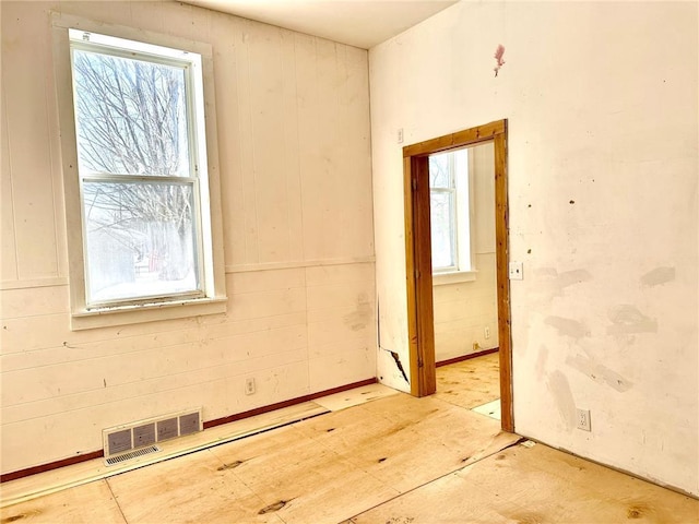 unfurnished room featuring visible vents