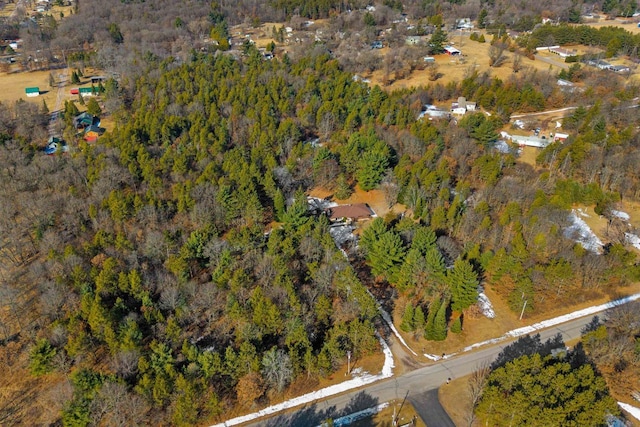 birds eye view of property featuring a view of trees