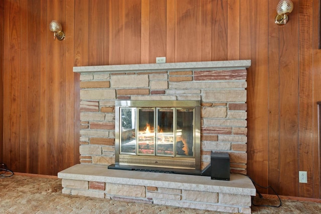 room details featuring wood walls and a fireplace