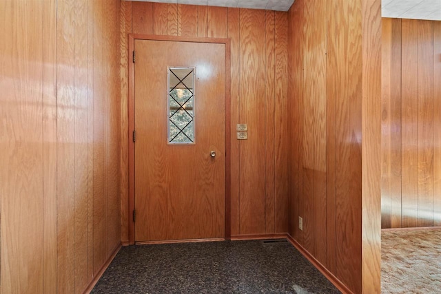 doorway featuring wood walls