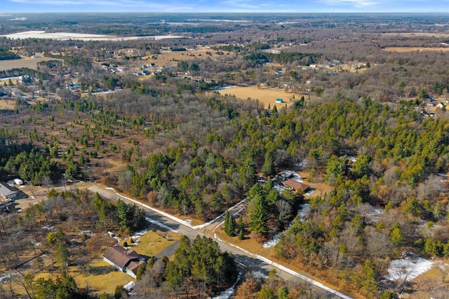 drone / aerial view featuring a forest view