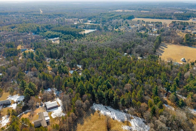 birds eye view of property featuring a wooded view