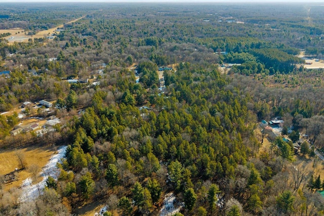 birds eye view of property featuring a wooded view