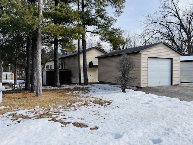 exterior space with an outbuilding and a detached garage