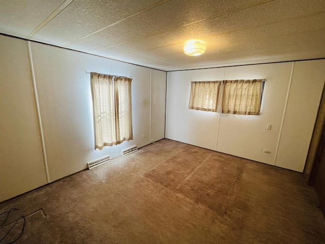 unfurnished bedroom with carpet, visible vents, and a textured ceiling