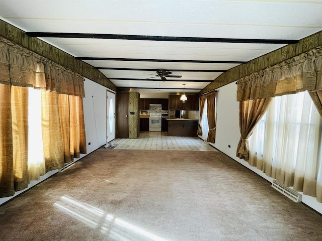 unfurnished living room featuring a ceiling fan, visible vents, beam ceiling, and light colored carpet