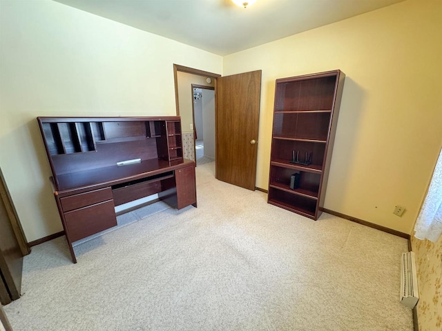 office with a baseboard heating unit, baseboards, and carpet flooring