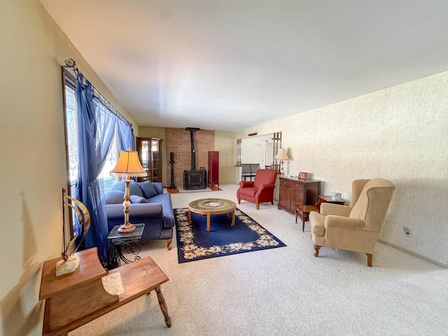 carpeted living area with wallpapered walls and a wood stove