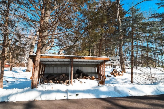 snowy yard featuring a pole building