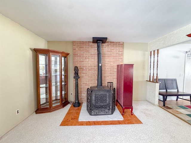 living area with a wood stove and carpet floors