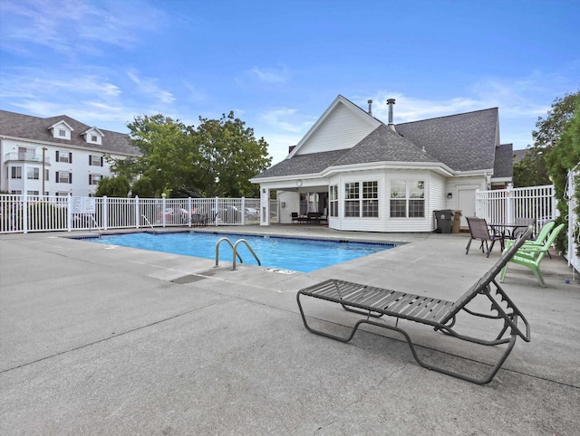 pool featuring fence and a patio