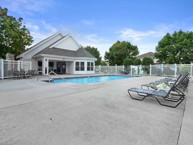 pool featuring a patio area and fence