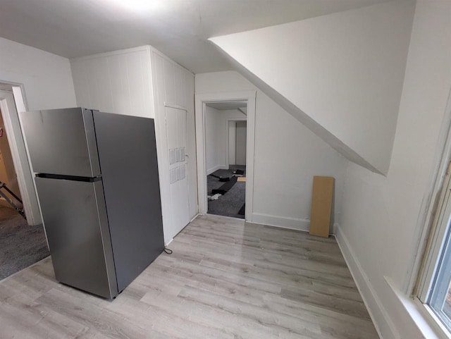 kitchen with light wood-type flooring and freestanding refrigerator