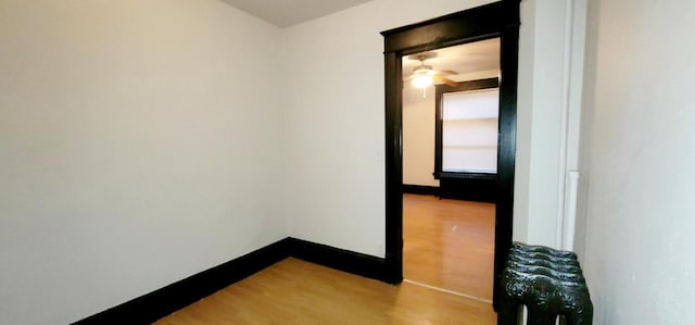 interior space featuring baseboards and wood finished floors