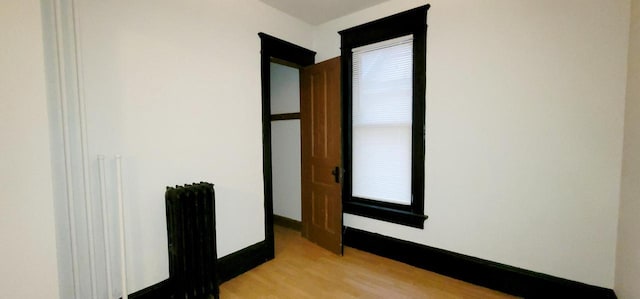 interior space featuring light wood-style flooring and baseboards