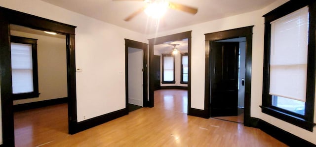 unfurnished room featuring light wood-type flooring and baseboards