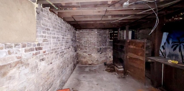 basement featuring brick wall