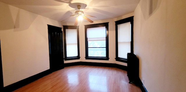 unfurnished room featuring light wood-style floors and baseboards