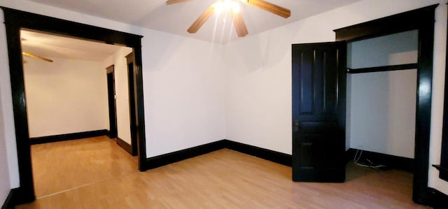 interior space with ceiling fan, light wood-style flooring, and baseboards