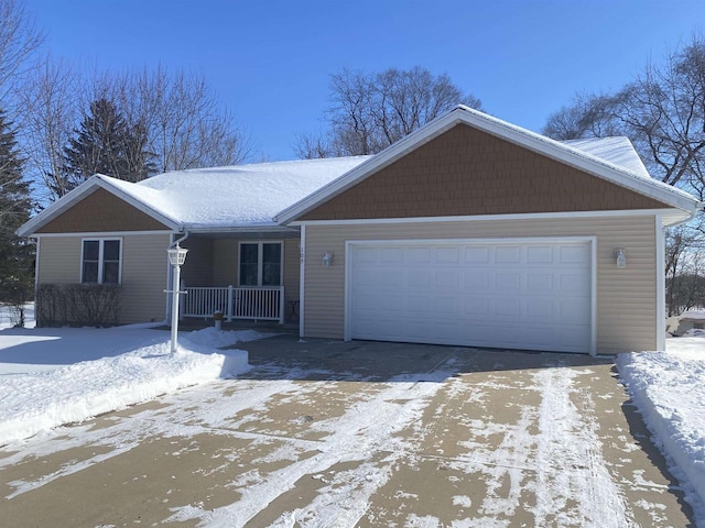 ranch-style home featuring a porch, an attached garage, and driveway