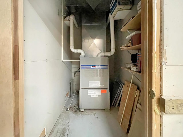 utility room featuring heating unit