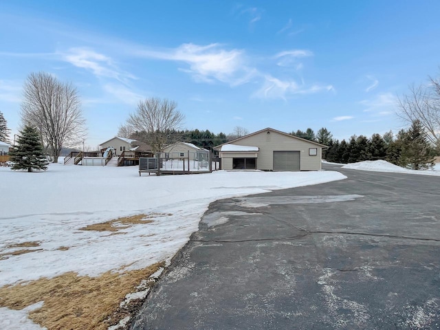 view of front of home with a garage and an outdoor structure