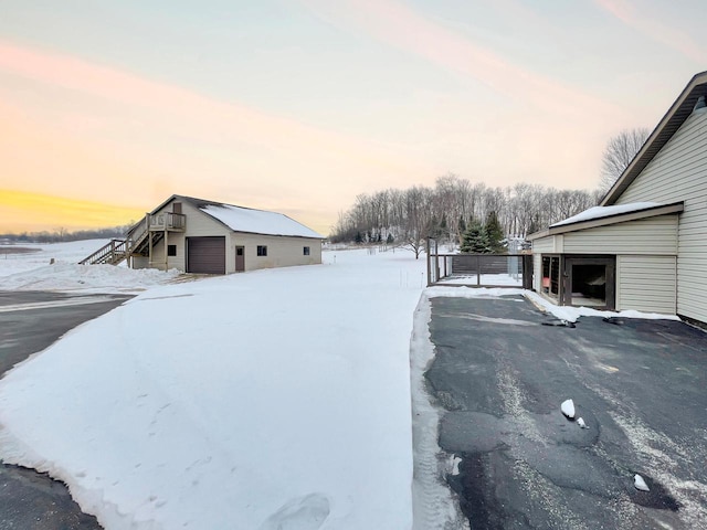 exterior space with a garage and an outbuilding