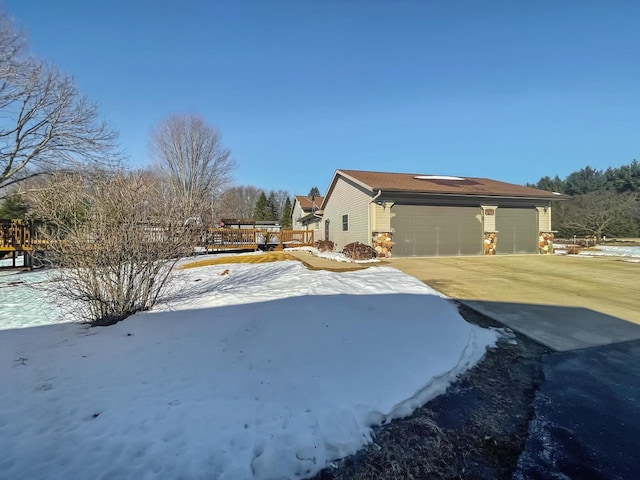 view of snow covered exterior with a garage