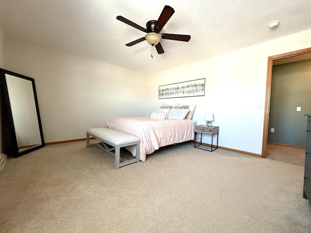 carpeted bedroom with ceiling fan and baseboards