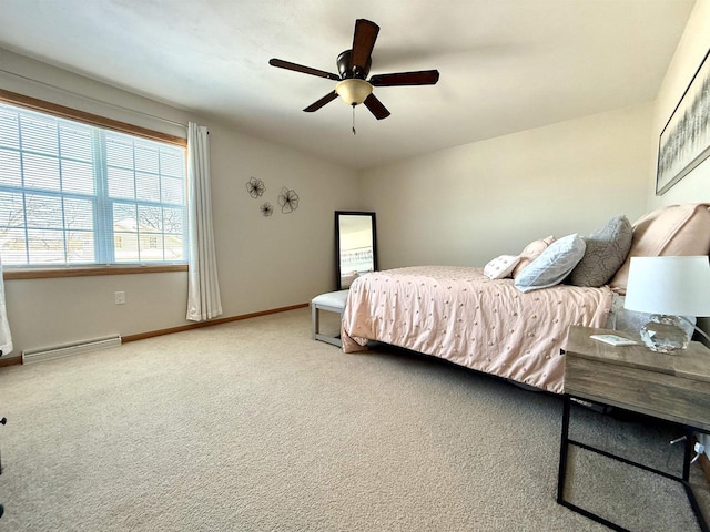 carpeted bedroom featuring a ceiling fan, baseboard heating, and baseboards