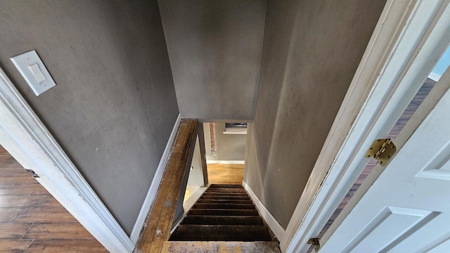 stairs with baseboards and wood finished floors