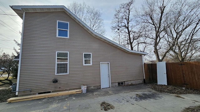 view of side of home featuring a patio area and fence