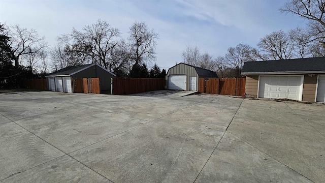 view of side of home featuring an outdoor structure and fence