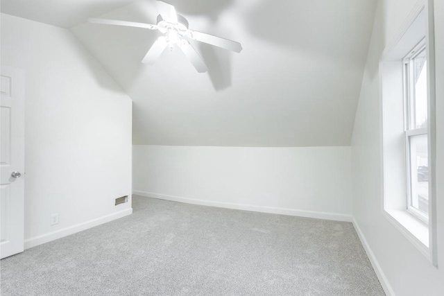 bonus room with baseboards, vaulted ceiling, and carpet flooring