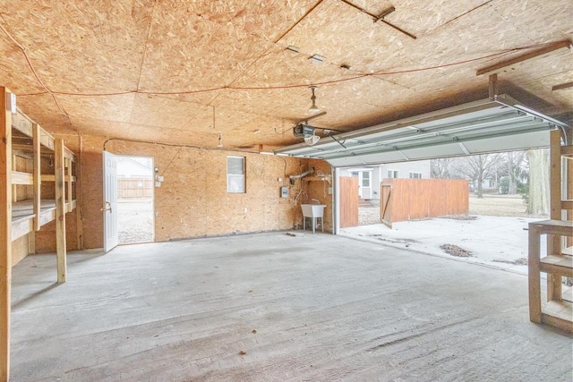 garage with a sink and a garage door opener